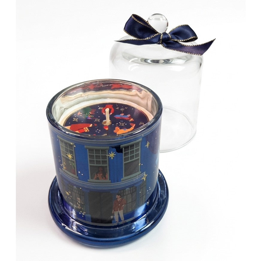 Candela mela e cannella in vetro blu metallizzato con cera decorata e campana trasparente con fiocco blu notte bordato d’oro