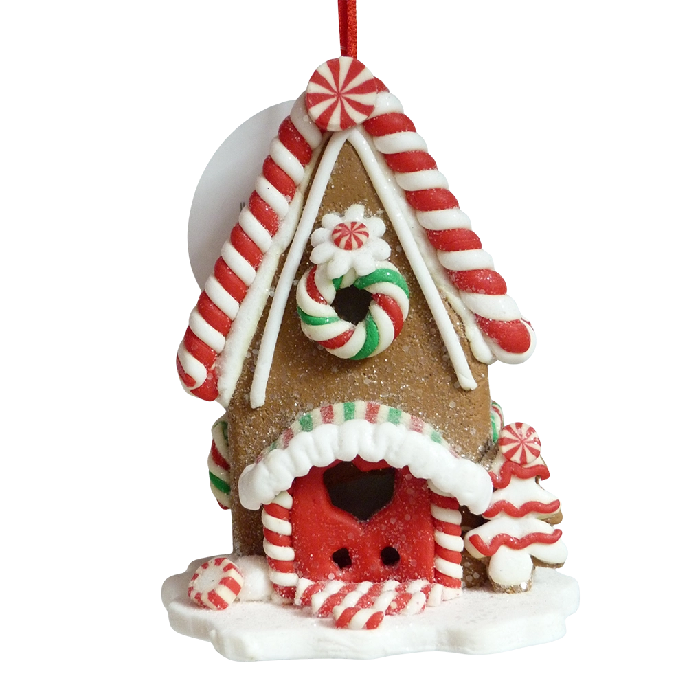 Casetta di pan di zenzero marrone con tetto a bastoncini rossi e bianchi, porta rossa con cuore e alberello di glassa