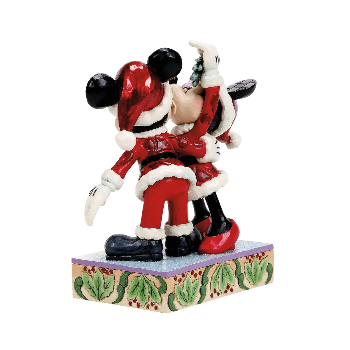 Topolino e Minnie visti di tre quarti da dietro: cappelli rossi con pompon bianco, braccio di Minnie alzato con il vischio e base con foglie di agrifoglio